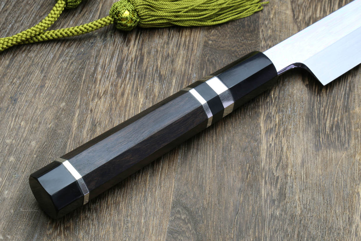 Dark handle Japanese kitchen knife with mirror-finished blade and striped grip rings