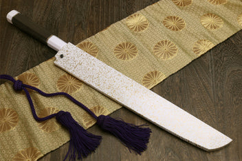 Japanese sushi sashimi knife with speckled white saya and dark handle, purple tassel cord