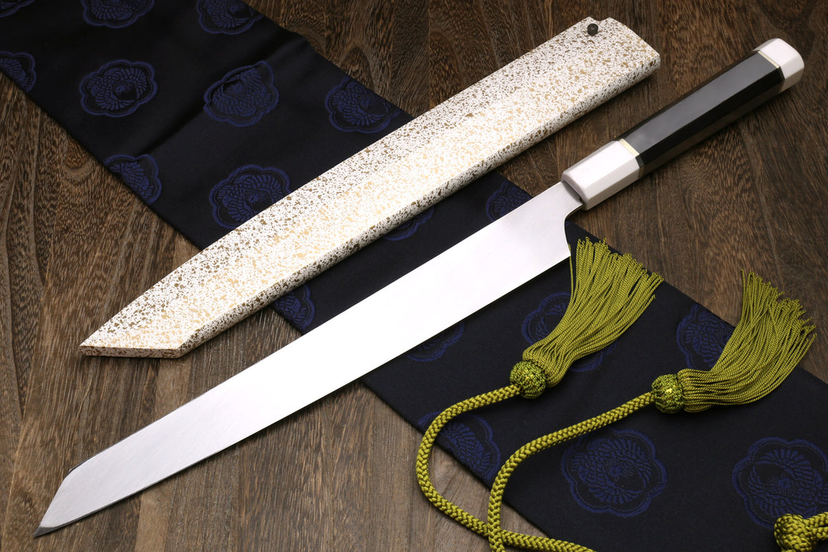 Japanese sushi knife with white steel blade, speckled sheath and dark handle