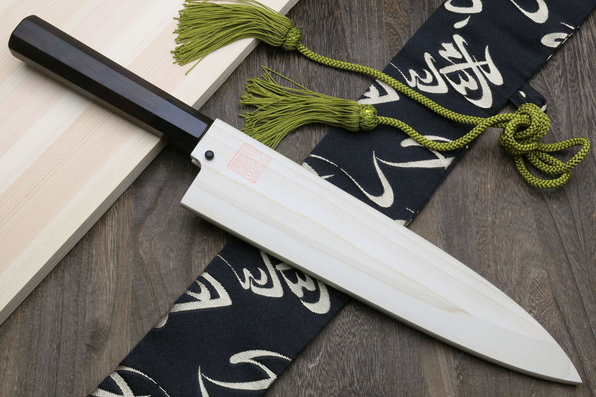 Japanese fish filet knife with ebony handle and silver blade, styled with green cord