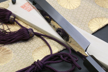 Sakimaru sushi knife with cord-wrapped handle and polished blade