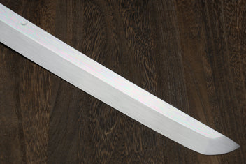Mirror-finished silver katana blade close-up, straight tip.