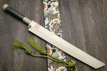 Mirror-finished Japanese knife with dark ebony handle and ornate dragon-pattern wrap