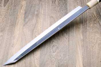 Yanagi kiritsuke knife with mirror-finished blade and dark handle with metallic trim