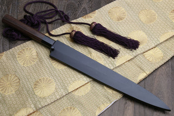 Yanagi sushi knife with dark saya, rosewood handle, and purple cord tassels