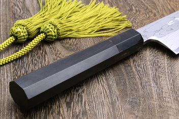 Knife handle and spine detail with green cord; white damascus blade