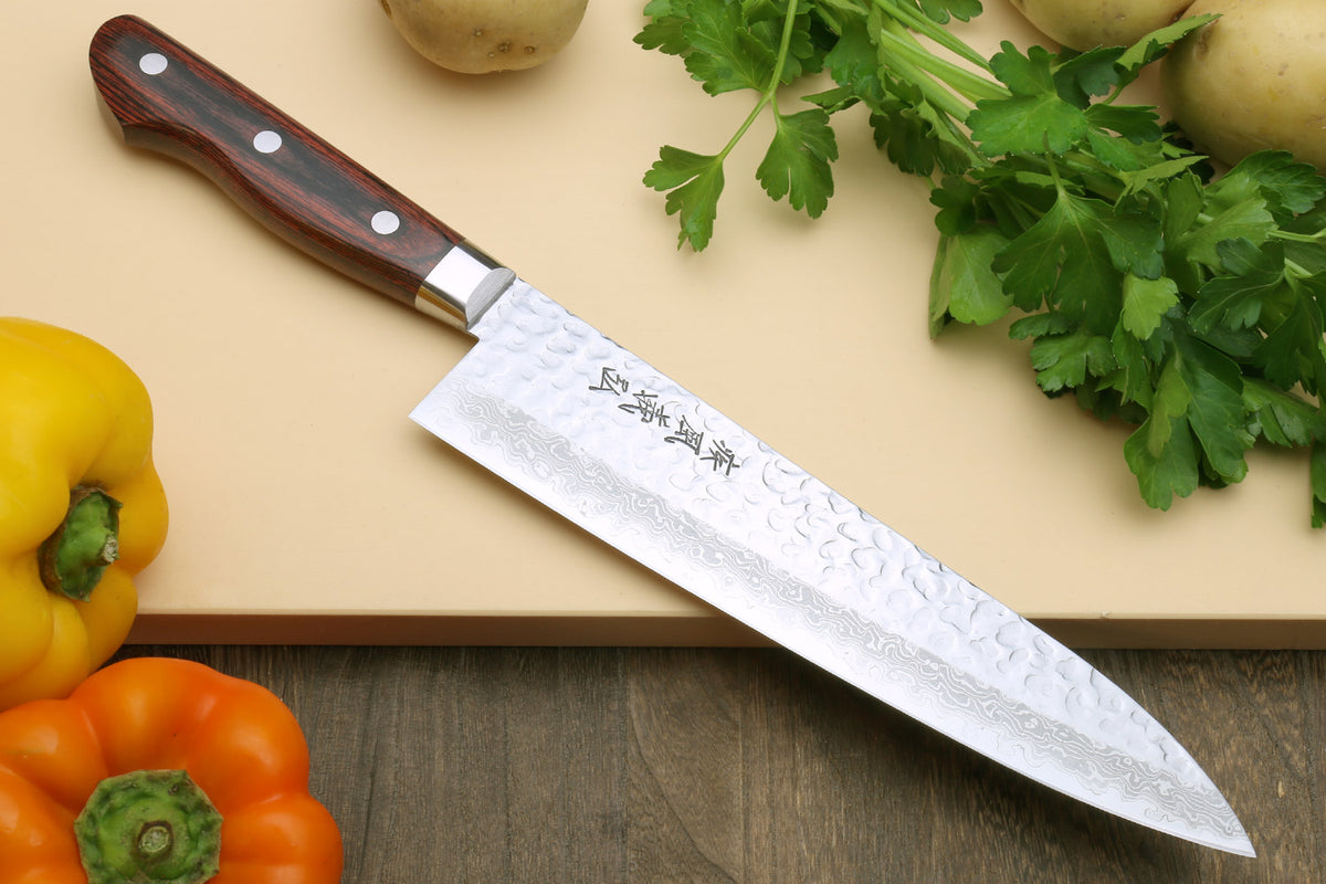 Damascus stainless gyuto knife with dark red handle and hammered blade texture