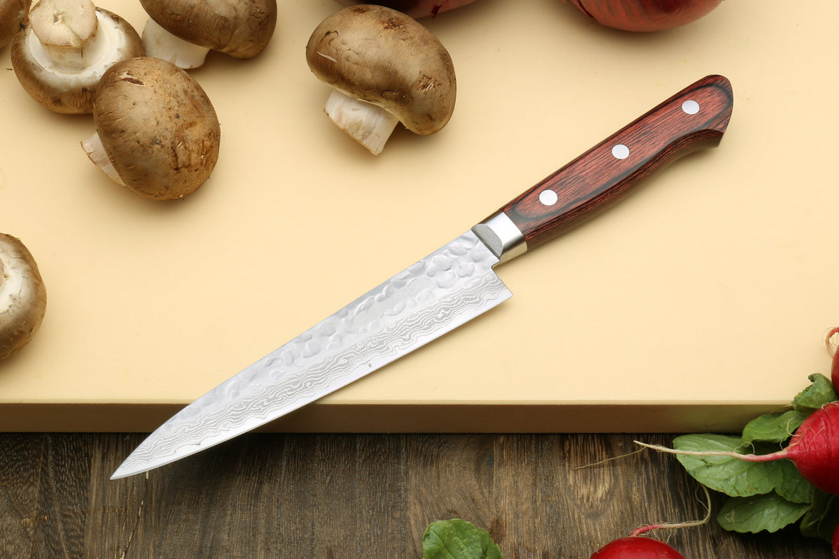 Nakiri and petty knives set, hammered Damascus blades with dark wood handles.