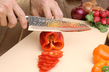 Damascus santoku knife with dark wood handle and hammered silver blade