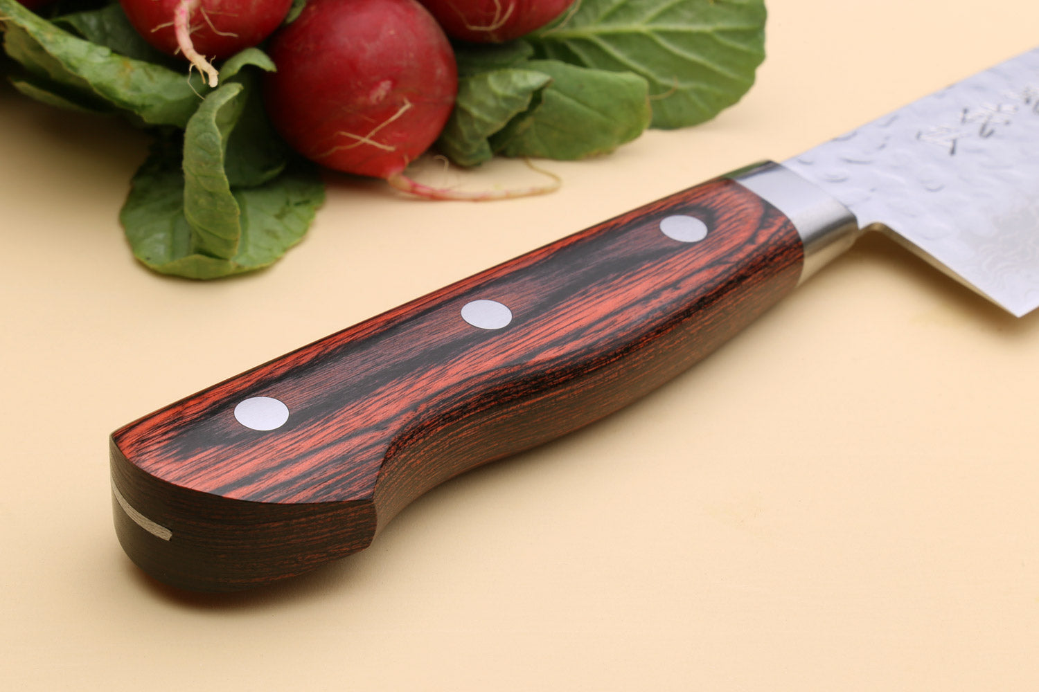 Mahogany handle of knife being shown off
